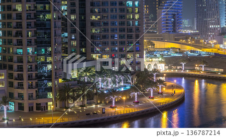 Water canal on Dubai Marina skyline at night timelapse. 136787214