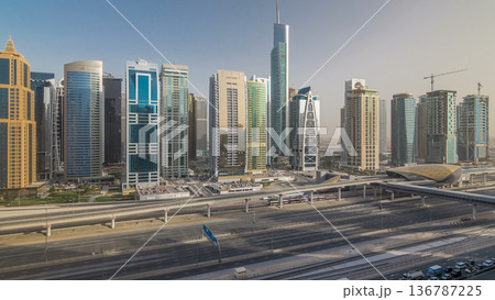 Aerial view of Jumeirah lakes towers skyscrapers timelapse with traffic on sheikh zayed road. 136787225