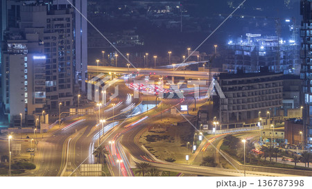 Aerial view of a road intersection in a big city night timelapse. 136787398