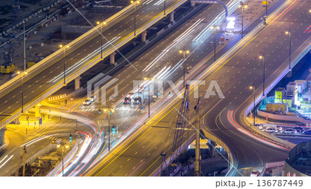 Night traffic on a busy intersection at Dubai downtown highway aerial timelapse 136787449