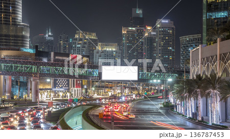 Car traffic on road near mall at night in downtown timelapse. Car traffic on road near mall at night in downtown timelapse. 136787453