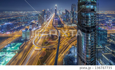 Scenic Dubai downtown skyline at night timelapse. Rooftop view of Sheikh Zayed road with numerous illuminated towers. Scenic Dubai downtown skyline at night timelapse. Rooftop view of Sheikh Zayed road with numerous illuminated towers. 136787735