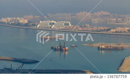 A breathtaking aerial view of the Palm Jumeirah during sunrise timelapse from a rooftop, Dubai, United Arab Emirates A breathtaking aerial view of the Palm Jumeirah during sunrise timelapse from a rooftop, Dubai, United Arab Emirates 136787759