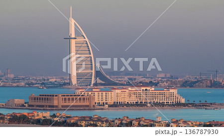 Dubai skyline with villas and Burj Al Arab during sunset timelapse. Dubai skyline with villas and Burj Al Arab during sunset timelapse. 136787930
