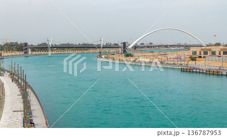 Two bridges over Dubai canal with a boat crossing under them timelapse. Two bridges over Dubai canal with a boat crossing under them timelapse. 136787953