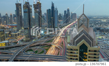 Modern skyscrapers and busy evening highways day to night timelapse in luxury Dubai city, Dubai, United Arab Emirates 136787961