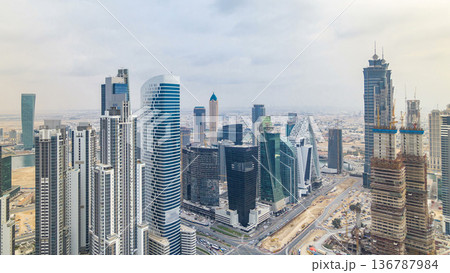 Dubai's business bay towers before sunset timelapse. Rooftop view of some skyscrapers and new towers under construction. Dubai's business bay towers before sunset timelapse. Rooftop view of some skyscrapers and new towers under construction. 136787984
