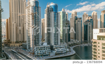 Dubai Marina at evening timelapse with trails of boats on the water and cars traffic, Dubai, UAE 136788094