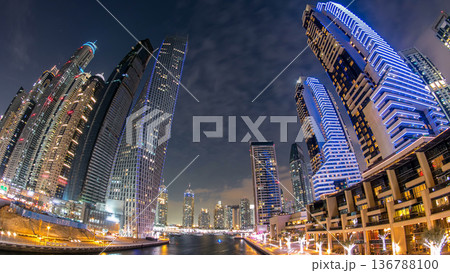 Dubai Marina towers and canal in Dubai day to night timelapse 136788100