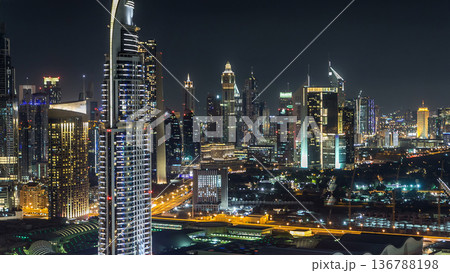Dubai downtown skyline timelapse at night. Rooftop view of Sheikh Zayed road with numerous illuminated towers. 136788198