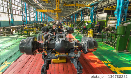 Conveyor assembly stage the body of tractor at big industrial factory timelapse Conveyor assembly stage the body of tractor at big industrial factory timelapse 136788281