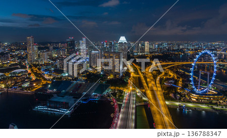 Skyline of Singapore with famous Singapore Ferries Wheel day to night timelapse at twilight Skyline of Singapore with famous Singapore Ferries Wheel day to night timelapse at twilight 136788347