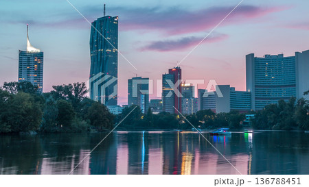 Vienna international center skyscrapers with Kaiserwasser lake reflection view day to night timelapse 136788451