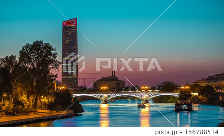 Seville skyline day to night timelapse with Torre Sevilla and Triana Bridge 136788514