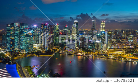 Aerial view of Singapore business district skyscrapers at evening with water reflections day to night timelapse Aerial view of Singapore business district skyscrapers at evening with water reflections day to night timelapse 136788521