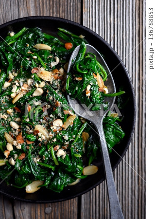 Overhead food photography of cooked spinach with roasted garlic 136788853