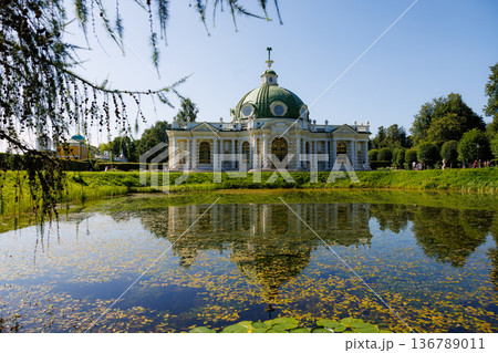 Beautiful summer day at the historic pavilion beside the tranquil pond in a lush garden setting Beautiful summer day at the historic pavilion beside the tranquil pond in a lush garden setting 136789011