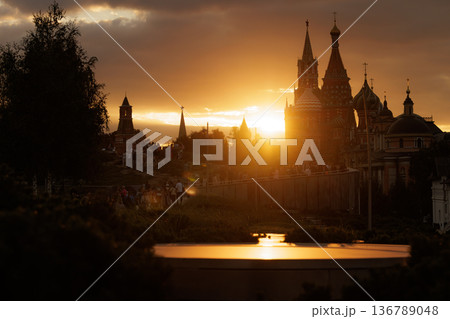 Sunset over historic buildings with silhouettes of spires in a park setting Sunset over historic buildings with silhouettes of spires in a park setting 136789048