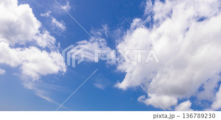 Panoramic photo of blue sky full of white cumulus clouds Panoramic photo of blue sky full of white cumulus clouds 136789230