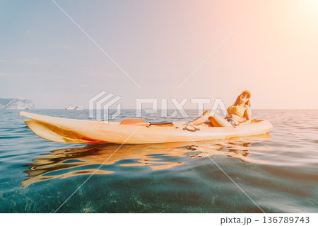 Kayaking Woman Water Leisure - Woman sitting in a kayak on the water during a leisure activity. Kayaking Woman Water Leisure - Woman sitting in a kayak on the water during a leisure activity. 136789743