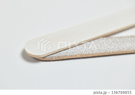 Emery board nail file close-up displaying an abrasive surface for nail care Emery board nail file close-up displaying an abrasive surface for nail care 136789855