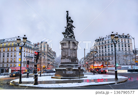 Snowy view of the Monument to Marshal Moncey at Place de Clichy in Paris, France. Features the bronze statue, classic buildings, and snow-covered streets on a winter day Snowy view of the Monument to Marshal Moncey at Place de Clichy in Paris, France. Features the bronze statue, classic buildings, and snow-covered streets on a winter day 136790577