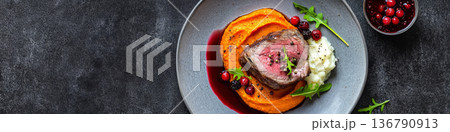 Sliced Venison Filet with Berry Garnish on Sweet Potato Puree 136790913