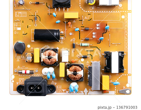 Low grade board from an television. Lower part of a brown circuit board, with fewer precious metal traces, that rely on base metals like copper and aluminum for scrap value. Isolated from above. Photo 136791003