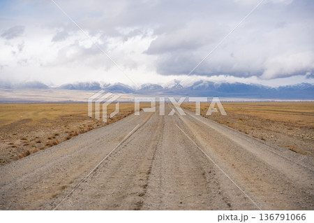 Road from the Mongolian border to Kosh-Agach Altai Russia in a remote mountain landscape. Scenic route through steppe and rugged terrain connecting two regions. Road from the Mongolian border to Kosh-Agach Altai Russia in a remote mountain landscape. Scenic route through steppe and rugged terrain connecting two regions. 136791066