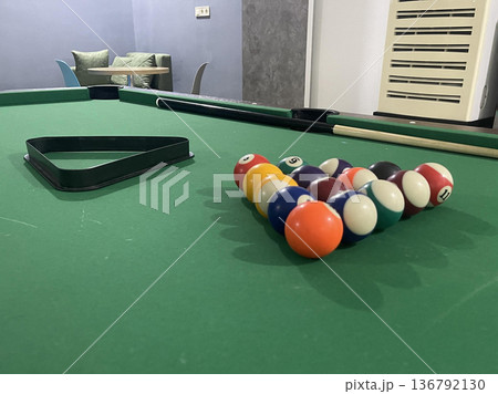 billiard balls with triangle are lying on a billiard table billiard balls with triangle are lying on a billiard table 136792130