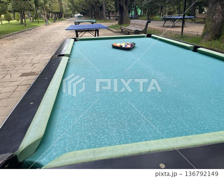 pool table with balls in a recreation park pool table with balls in a recreation park 136792149