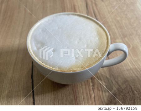 a cappuccino cup isolated on wooden table a cappuccino cup isolated on wooden table 136792159