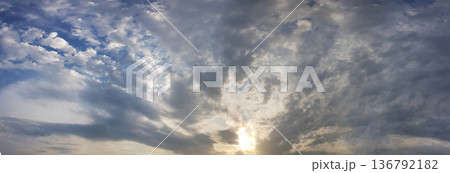 Panorama of cloudy sky and sun Panorama of cloudy sky and sun 136792182