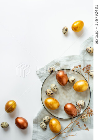 Golden and bronze Easter eggs in a grey plate Golden and bronze Easter eggs in a grey plate 136792481