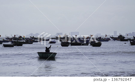 Vietnamese Fishing Boats Near Coastal City Skyline 136792847
