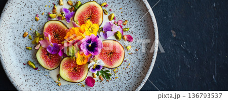 Fresh Figs with Edible Flowers and Pistachios on Ceramic Plate 136793537