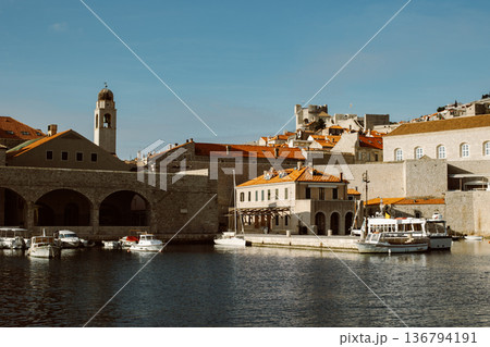 Amazing view of Dubrovnik and the boat in a marina on a sunny day. Amazing view of Dubrovnik and the boat in a marina on a sunny day. 136794191