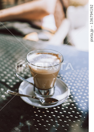 Cup of coffee latte on a table in a street cafe. 136794192