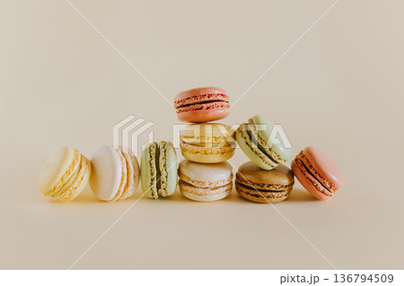 Tasty french macarons on a peach pastel background. 136794509