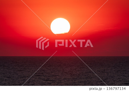 Beautiful red and orange sunrise over the sea. Beautiful red and orange sunrise over the sea. 136797134