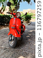 Red vintage scooter parked on 136797259