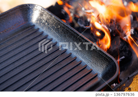 Grilling on an open flame creates savory meals in the heart of outdoor cooking 136797636