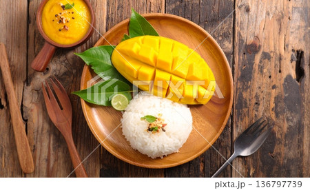 mango slice with sticky rice on the wooden table, top view mango slice with sticky rice on the wooden table, top view 136797739