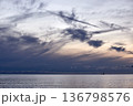 Dramatic seascape at sunset with cirrus clouds and small ship on horizon, calm ocean and evening sky 136798576