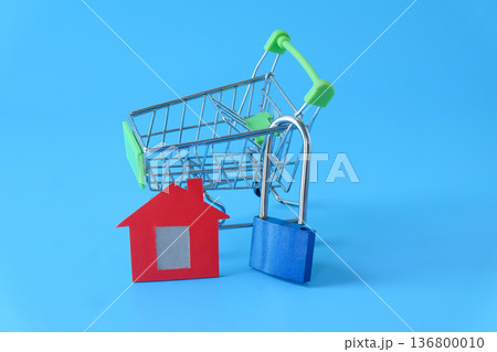 Mini red house and lock on background. Mini red house and lock on background. 136800010