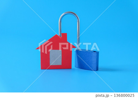 Mini red house and lock on background. 136800025