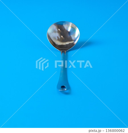 Big stainless spoon on color background. Big stainless spoon on color background. 136800062