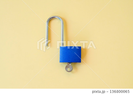Unlocked blue padlock with key on color background. Unlocked blue padlock with key on color background. 136800065