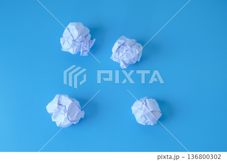 A crumpled sheet of paper on blue background. A crumpled sheet of paper on blue background. 136800302