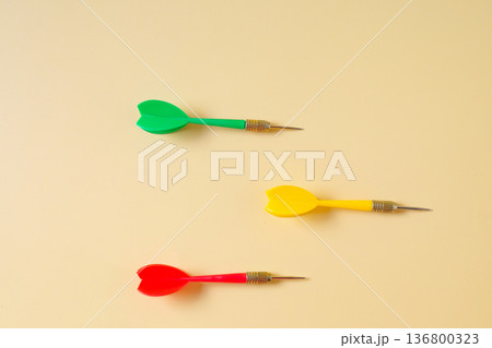 Colorful plastic darts arrow on color background. Colorful plastic darts arrow on color background. 136800323